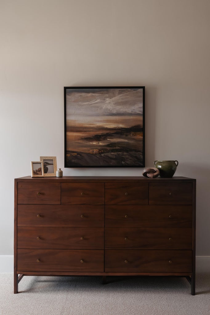 Dark wood-finish dresser featuring nine drawers with circular hardware