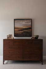 Dark wood-finish dresser featuring nine drawers with circular hardware