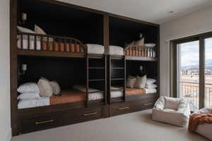 Built-in wood-finish bunk beds with integrated ladders and wall-mounted sconces