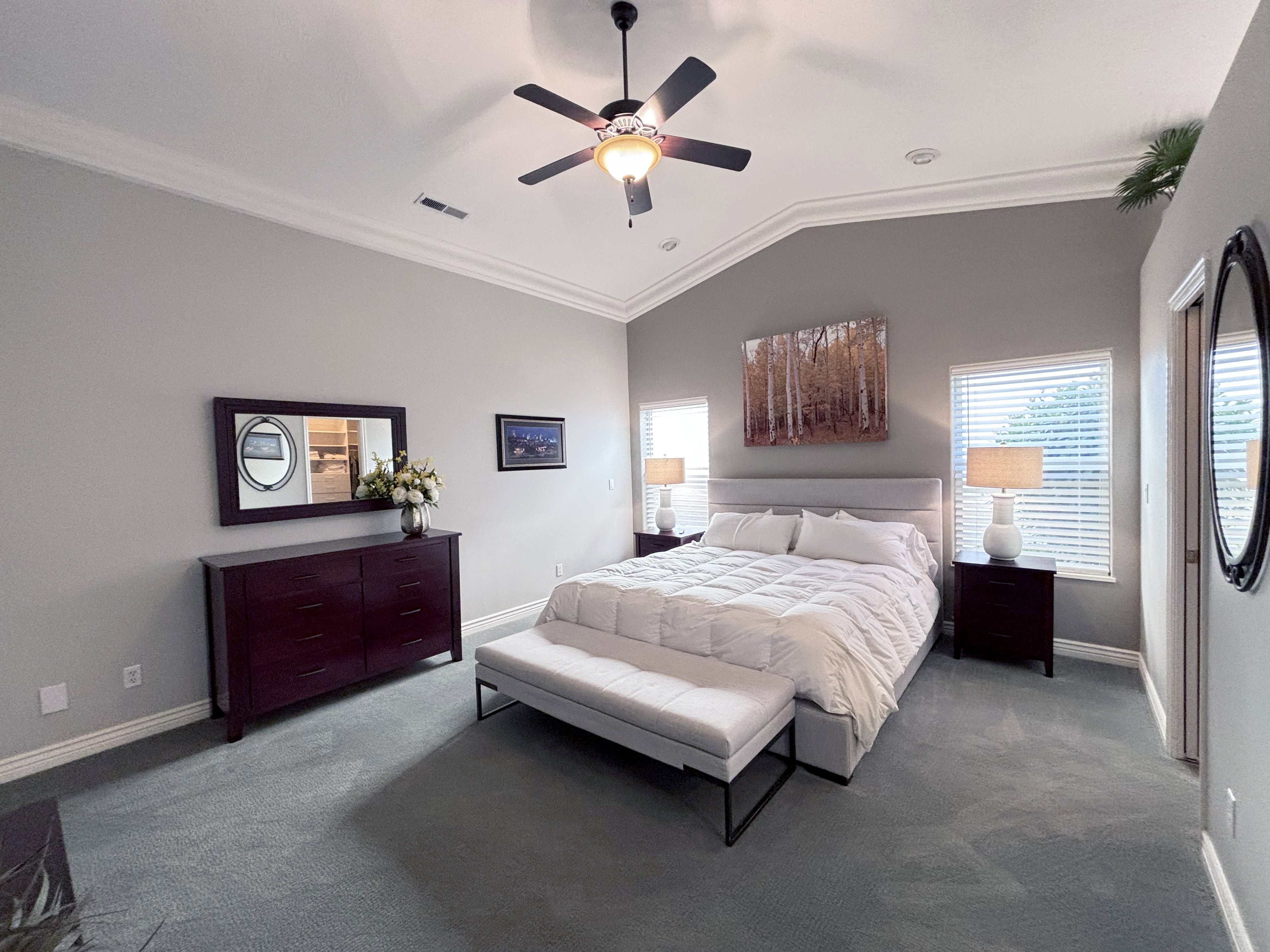 Bedroom featuring a vaulted ceiling with crown molding, a ceiling fan, and carpet flooring