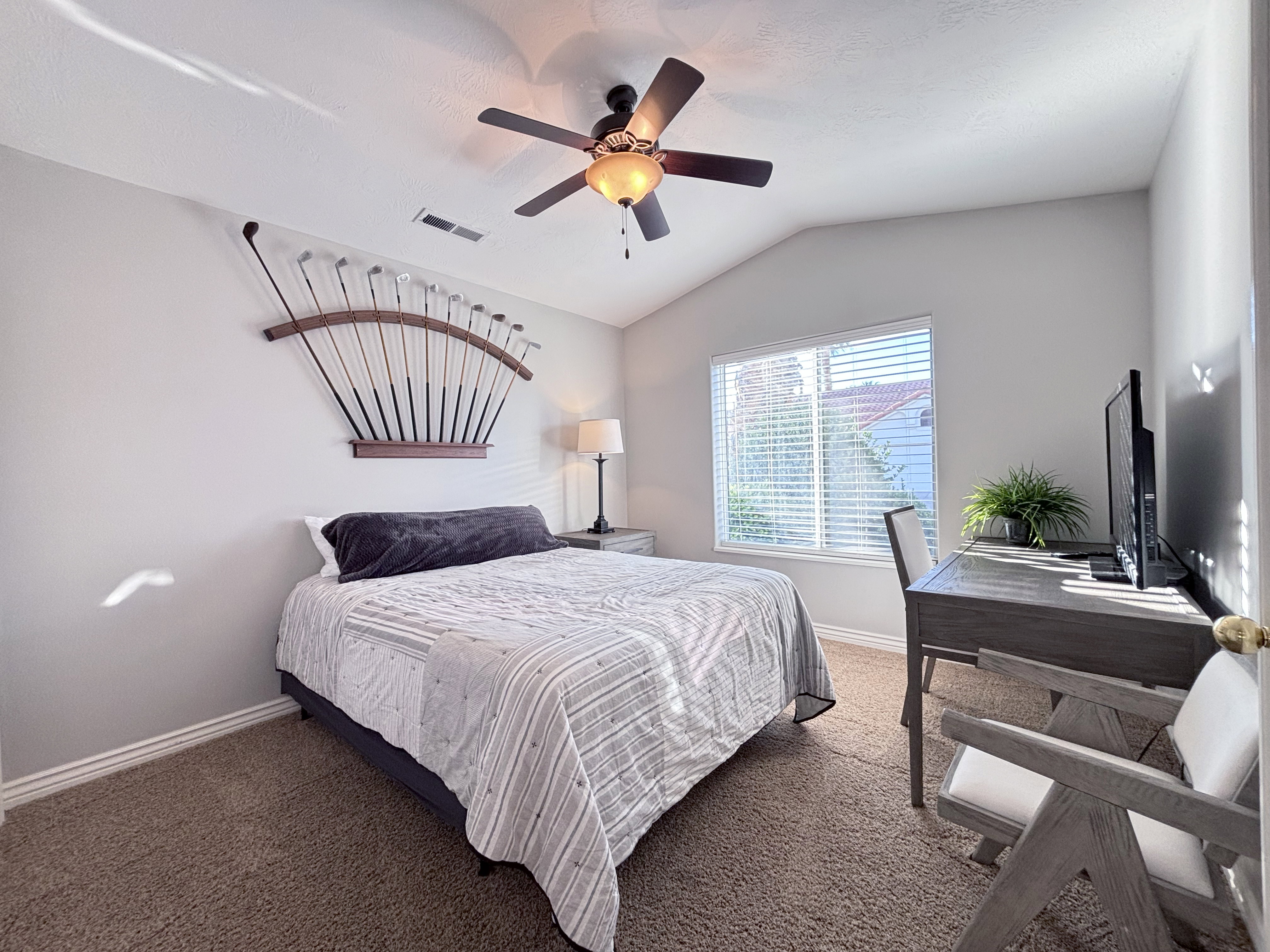Bedroom featuring a vaulted ceiling, ceiling fan with integrated lighting, and a window with blinds