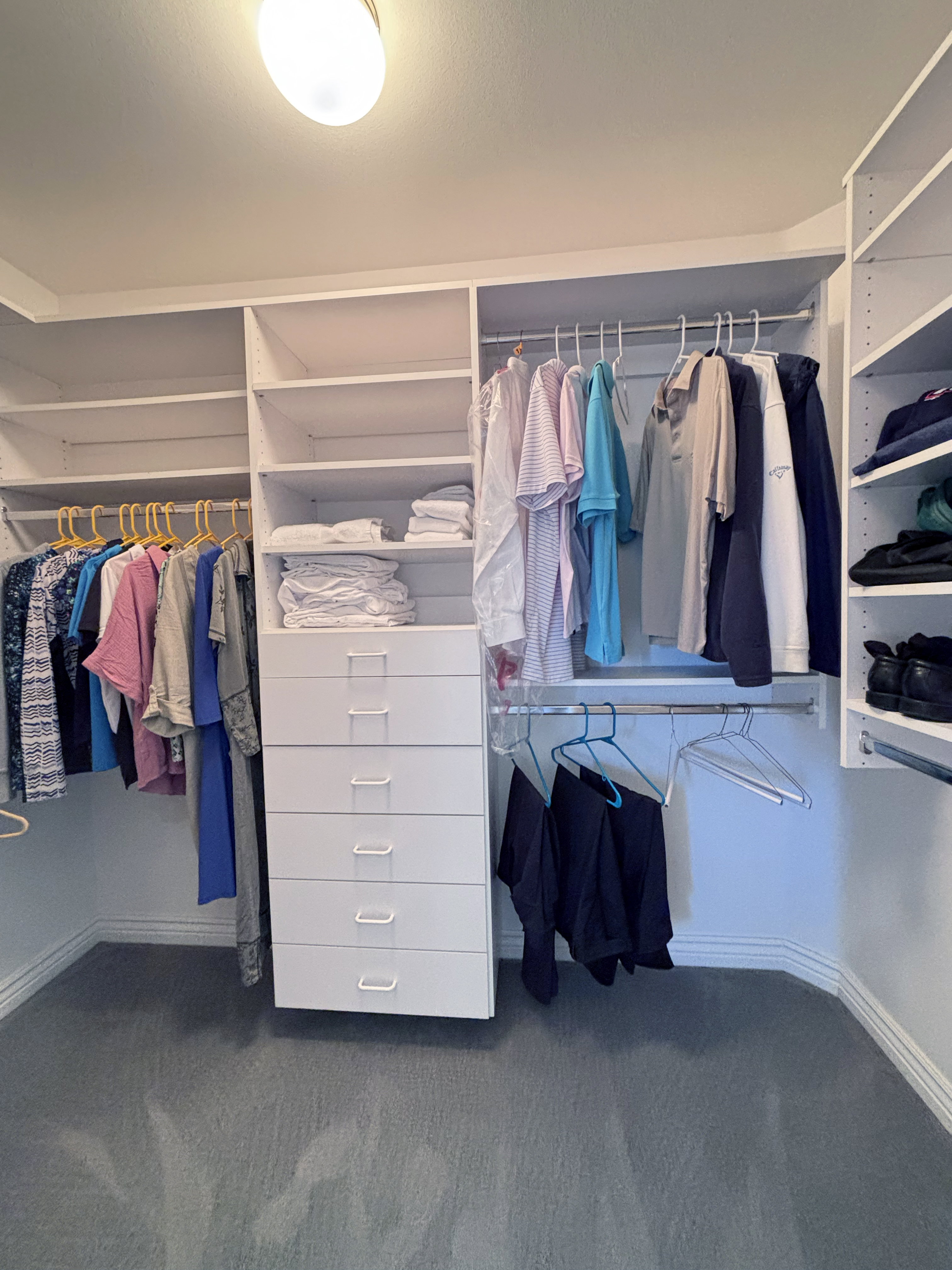 Custom closet system featuring white shelving and drawers