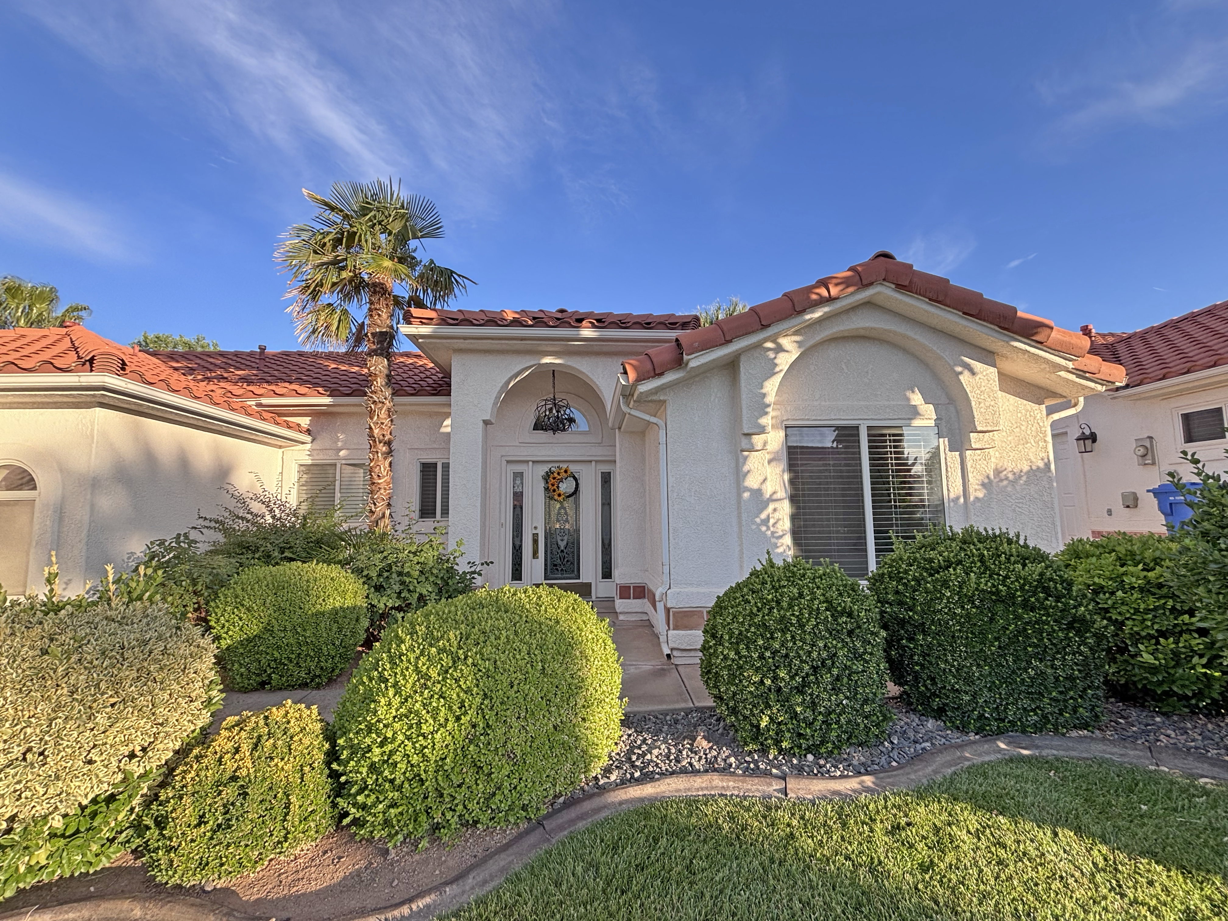 Mediterranean-style residence featuring a tile roof and stucco exterior