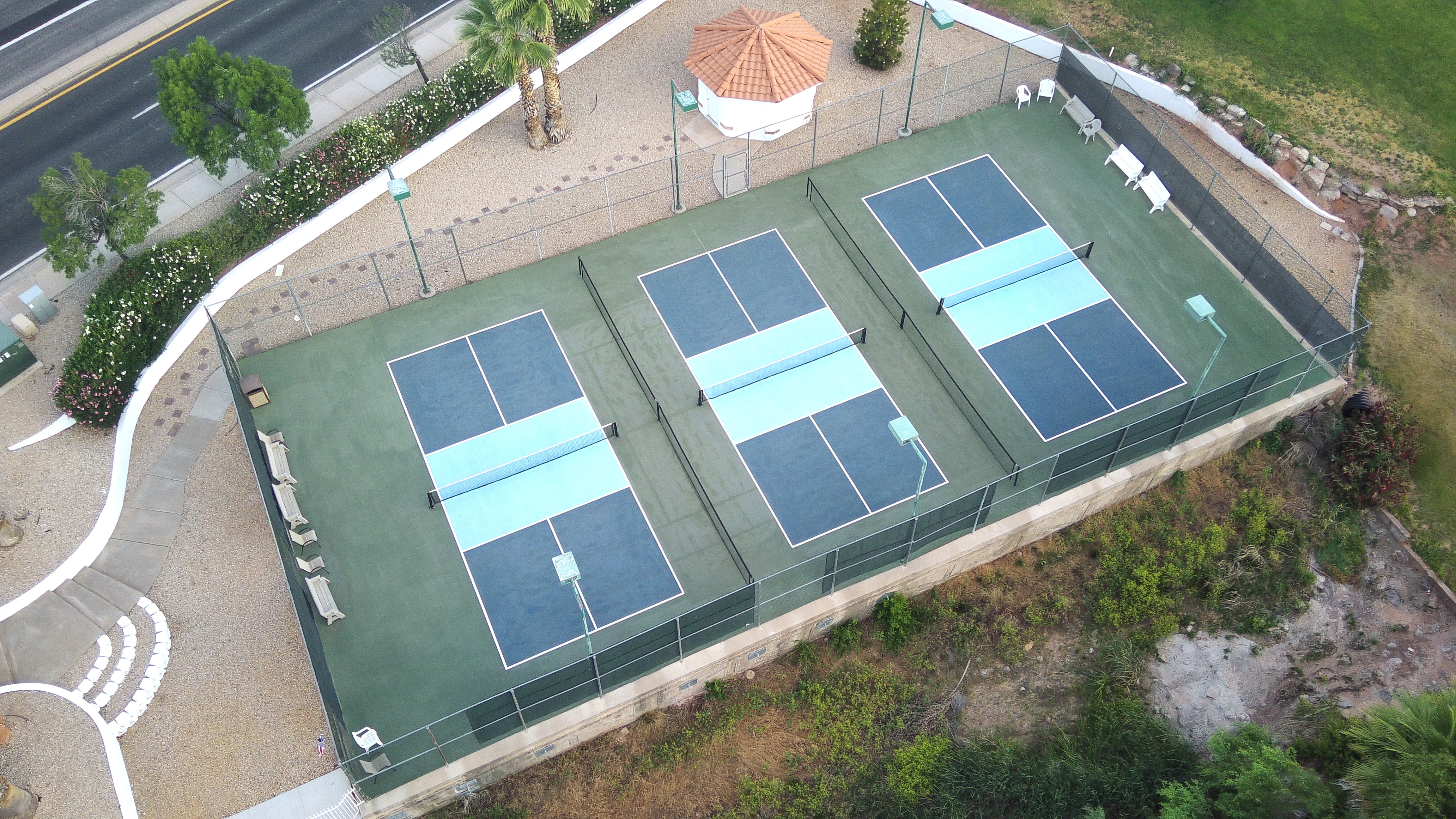 Three dedicated pickleball courts featuring blue and green surfacing