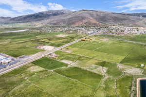 Expansive land parcels featuring green fields and established roadways