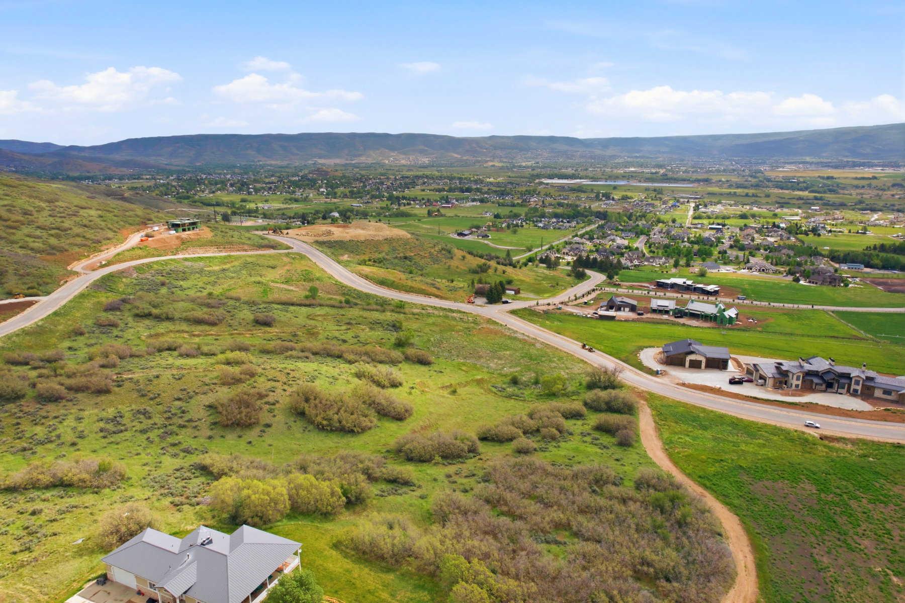 Expansive undeveloped land featuring rolling hills and distant mountain ranges