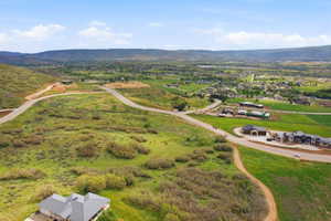 Expansive undeveloped land featuring rolling hills and distant mountain ranges