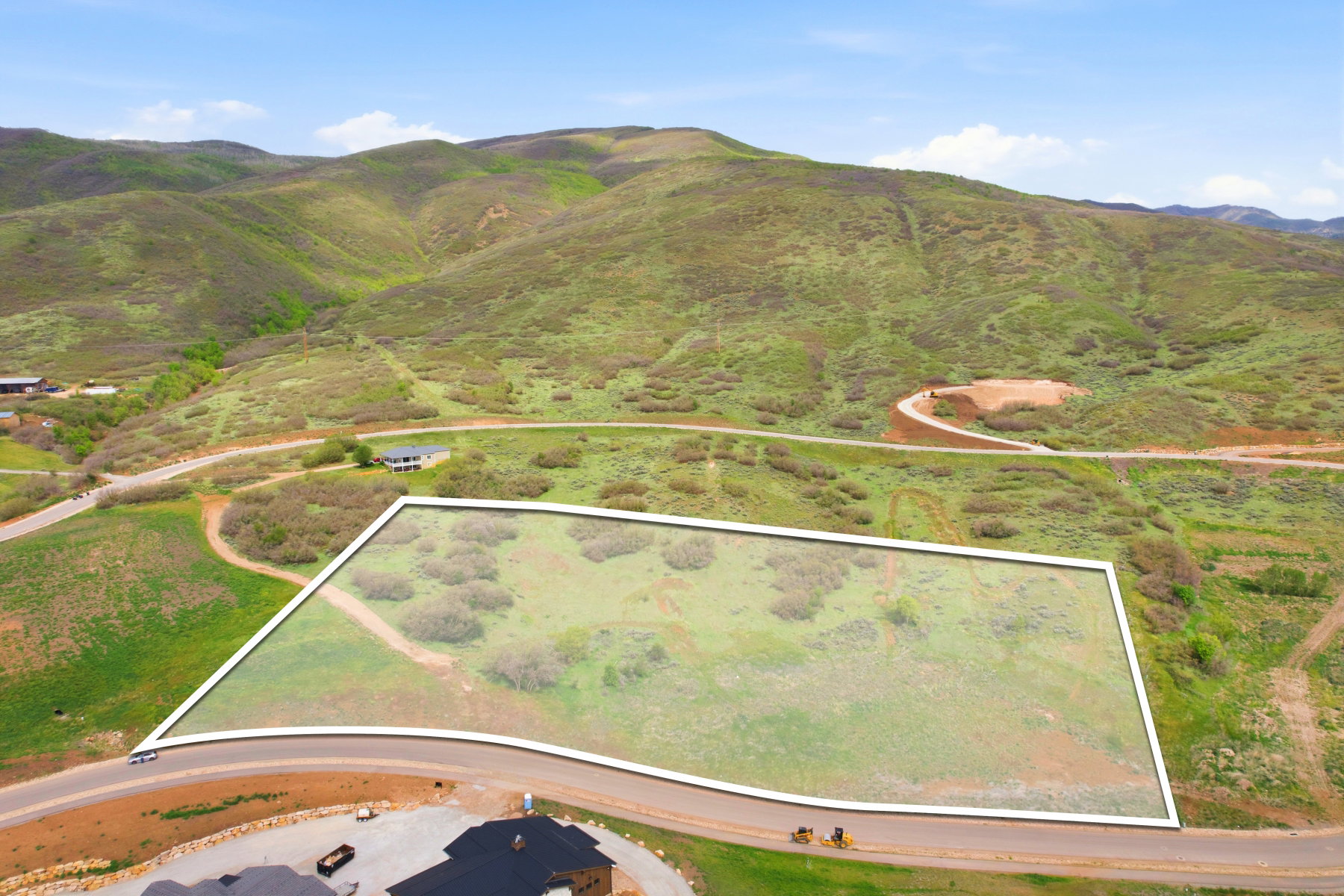 Expansive land parcel featuring natural topography and surrounding green hills