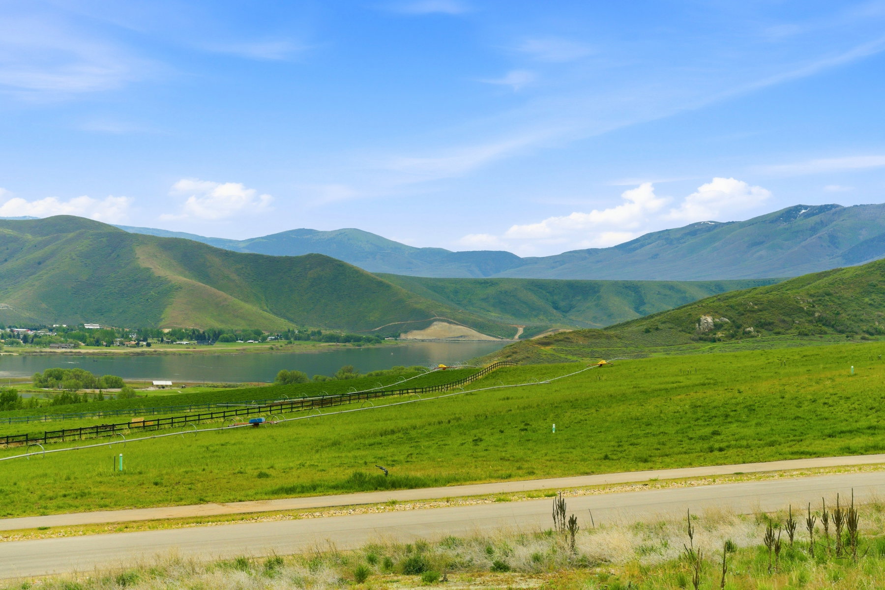 Expansive verdant landscape featuring rolling hills and distant mountains