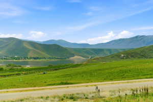 Expansive verdant landscape featuring rolling hills and distant mountains