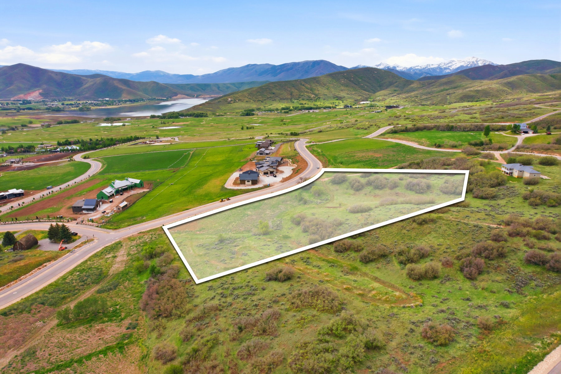Expansive undeveloped land parcel featuring natural shrubbery and surrounding green hills