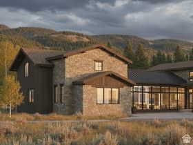 Stone and wood-sided exterior featuring multiple gabled rooflines, large picture windows, and a metal roof section