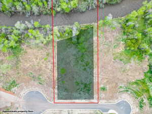 Expansive undeveloped parcel featuring a river frontage, a wooded border, and direct road access