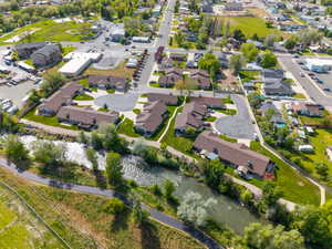 Multi-unit property situated alongside a river with a paved pathway