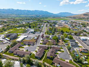 Residential community with varied housing styles, surrounded by established landscaping and paved roadways