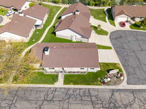 Residential property with a brown shingle roof and light-colored siding