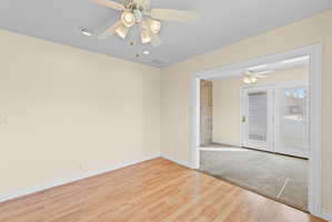 Room featuring wood-finish flooring, recessed lighting, and a ceiling fan