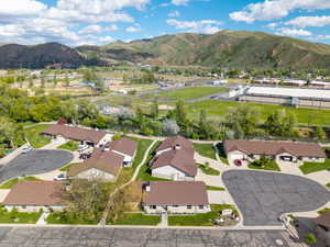 Residential community featuring a cul-de-sac, paved driveways, and brown shingle roofing