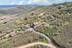 Expansive mountain landscape featuring multiple properties nestled into natural terrain