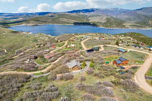Aerial perspective showcasing a residential area with a prominent body of water and mountainous terrain
