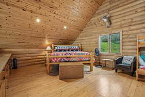 Interior room featuring log construction walls and wood-finish flooring
