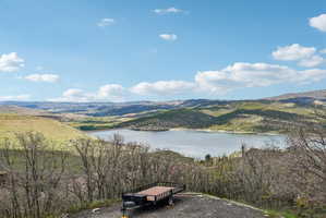 Expansive lake and mountain scenery featuring natural terrain and distant foothills