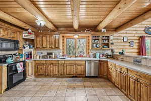 U-shaped kitchen featuring wood cabinetry, stainless steel appliances, and a tiled backsplash