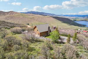 Wood-sided residence with a pitched roof and stone chimney