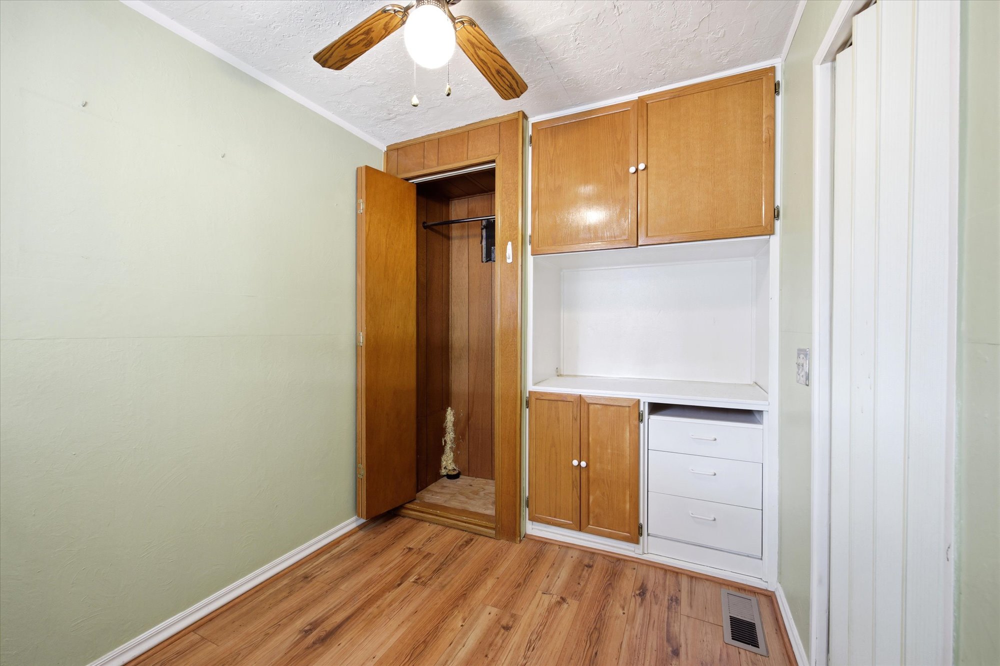 Built-in cabinetry with wood-finish doors and white drawers