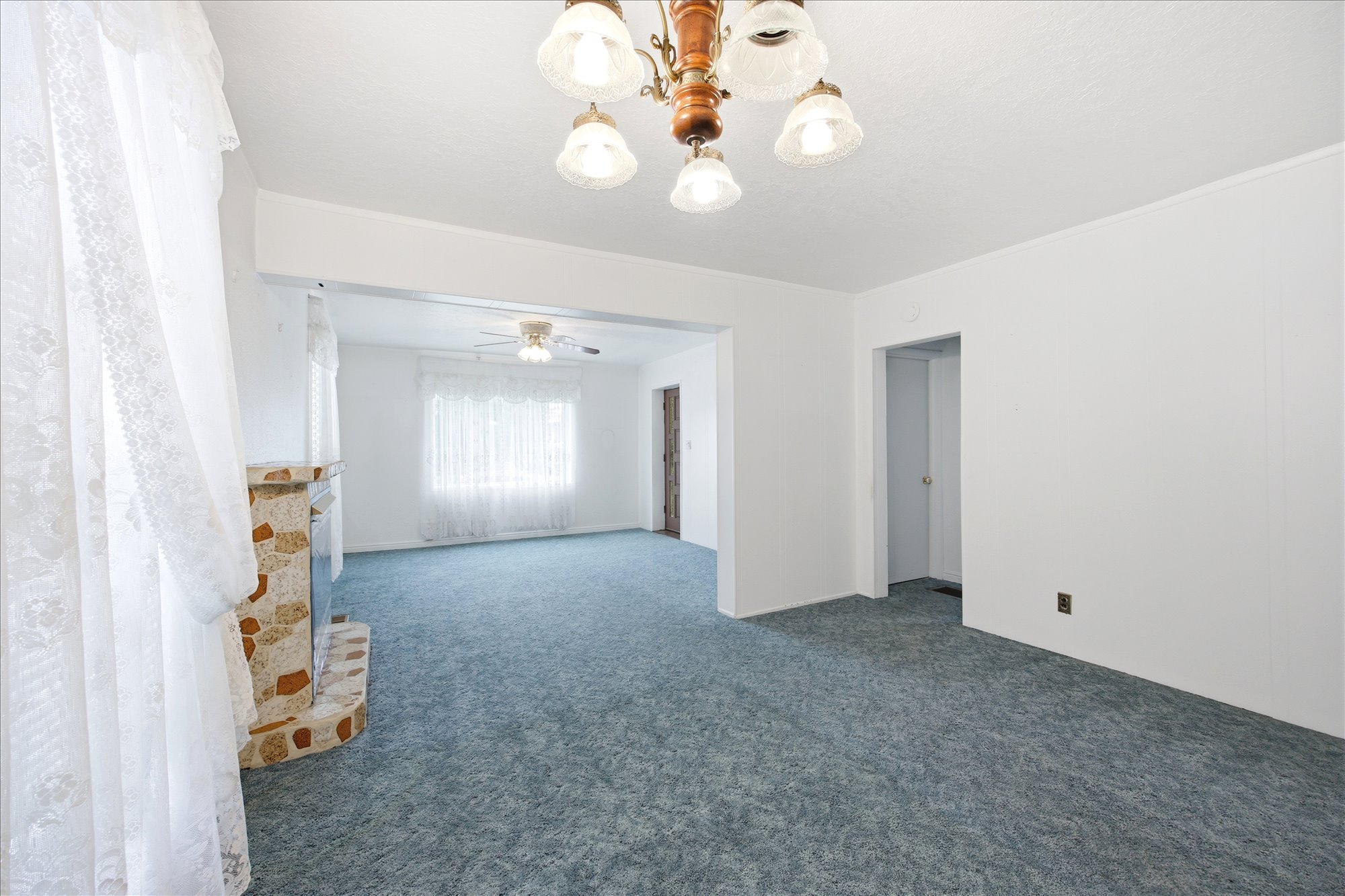 Living area with wall-to-wall carpeting and neutral white walls