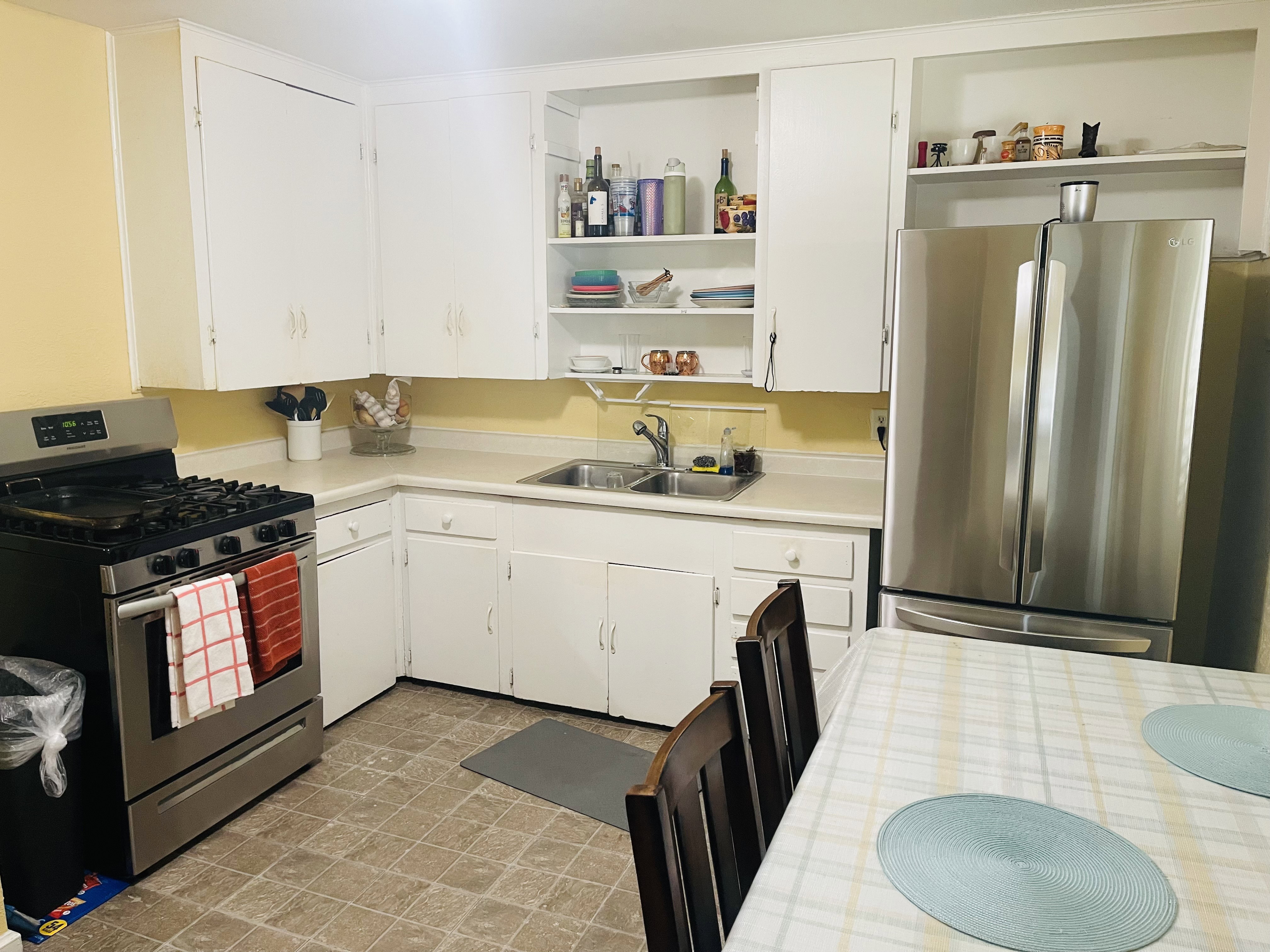 Kitchen featuring white cabinetry, light countertops, and square tile flooring