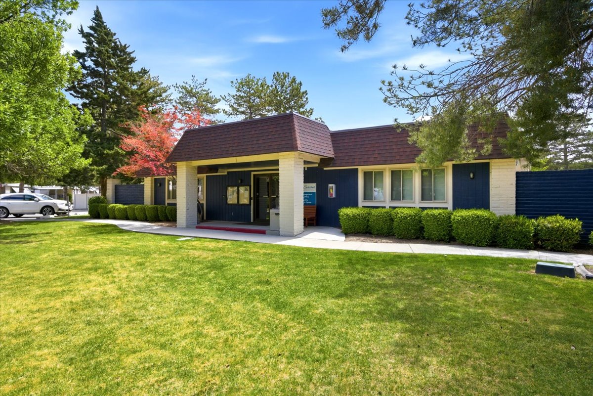 Exterior building featuring blue siding, white brick, and a brown shingle roof