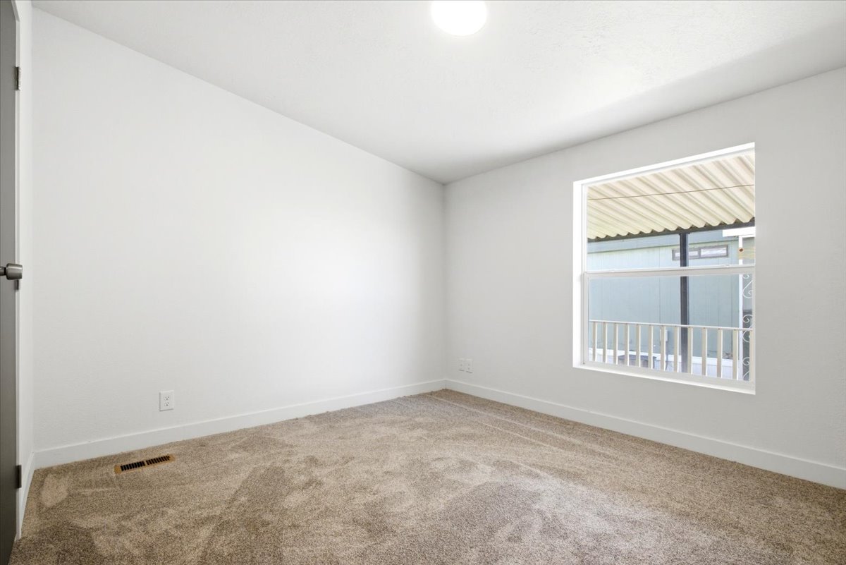 Neutral tone carpet flooring with white baseboards