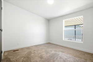 Neutral tone carpet flooring with white baseboards