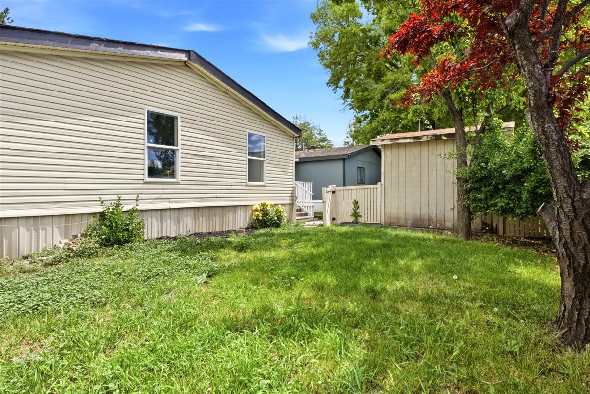 Exterior siding in a neutral tone with white trim windows