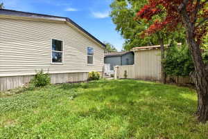 Exterior siding in a neutral tone with white trim windows