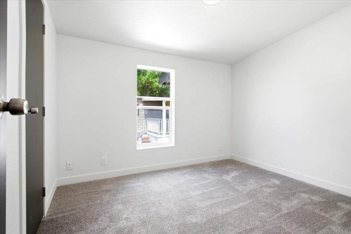 Neutral-toned room with a single window and recessed lighting