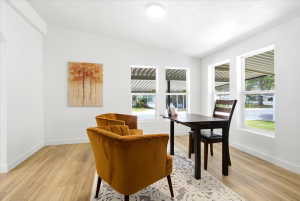 Bright interior space featuring light wood-finish flooring and white walls