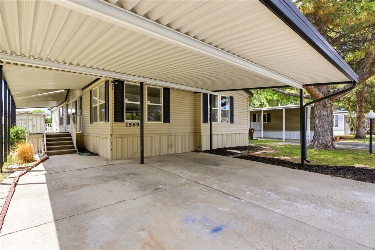Covered carport featuring a concrete pad and direct access to the residence
