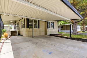 Covered carport featuring a concrete pad and direct access to the residence