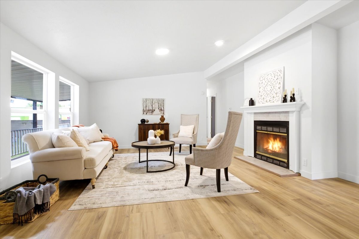 Living area featuring light wood-finish flooring and recessed lighting