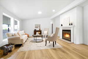 Living area featuring light wood-finish flooring and recessed lighting