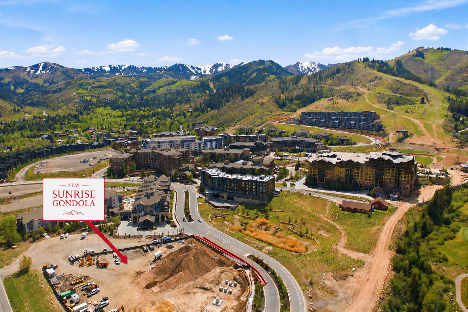Mountain landscape featuring a partially developed property site with surrounding multi-story buildings and infrastructure