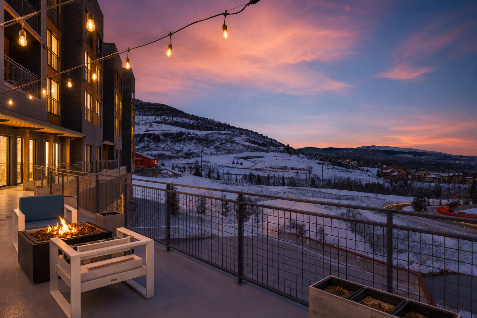 Expansive outdoor patio area featuring string lighting and a built-in fire pit