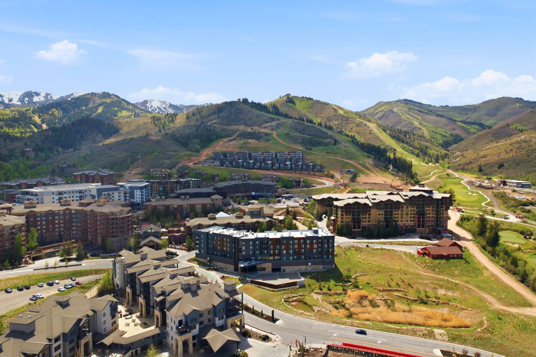 Expansive mountain landscape featuring multiple residential complexes and golf course elements
