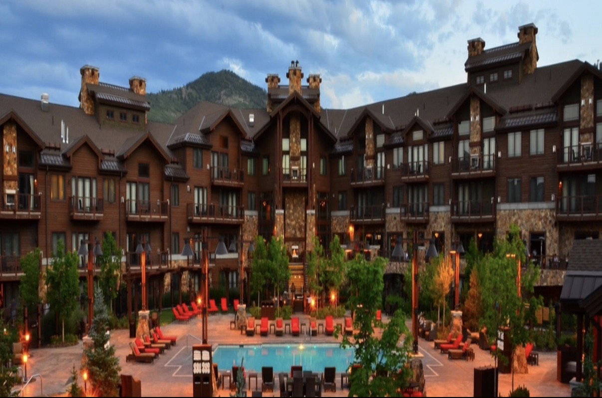 Expansive multi-story building featuring wood siding and stone accents