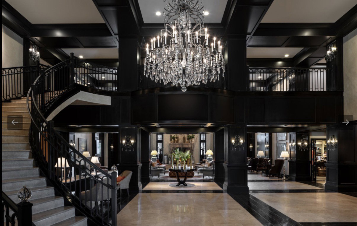 Grand foyer featuring a multi-level layout and a sweeping staircase with ornate iron railings