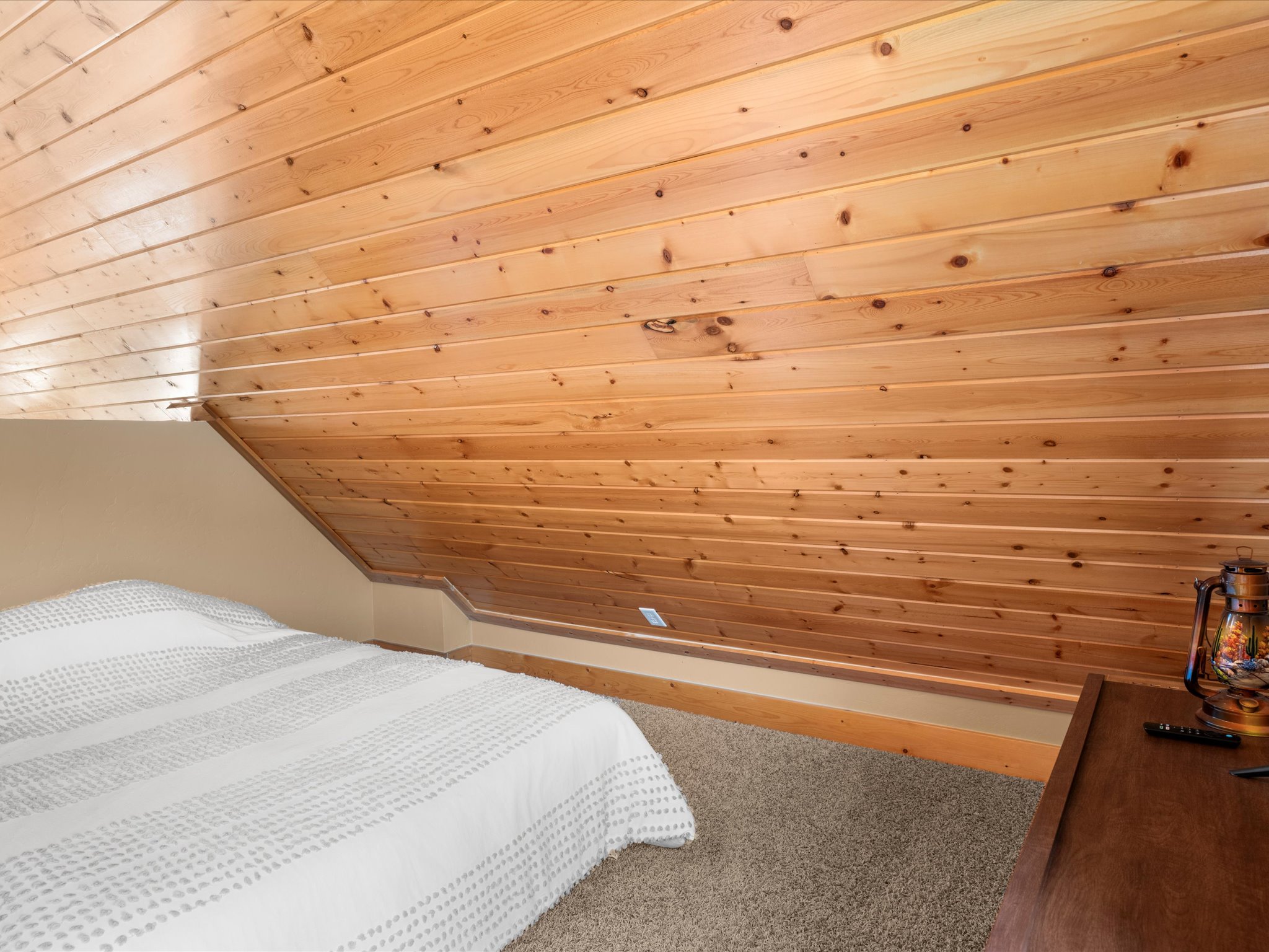 Wood-paneled sloped ceiling and wall detail