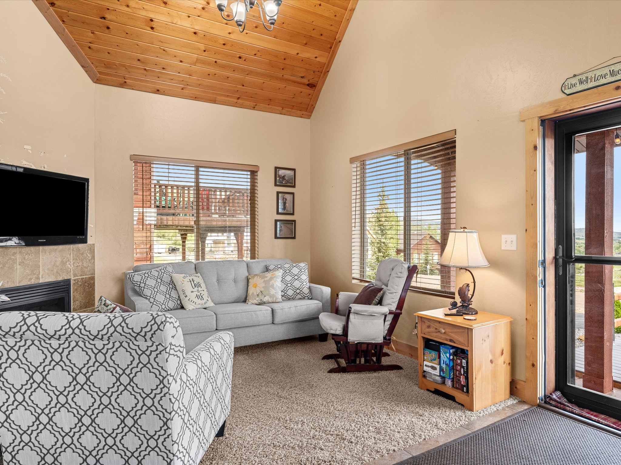 Vaulted wood-plank ceiling with a decorative chandelier
