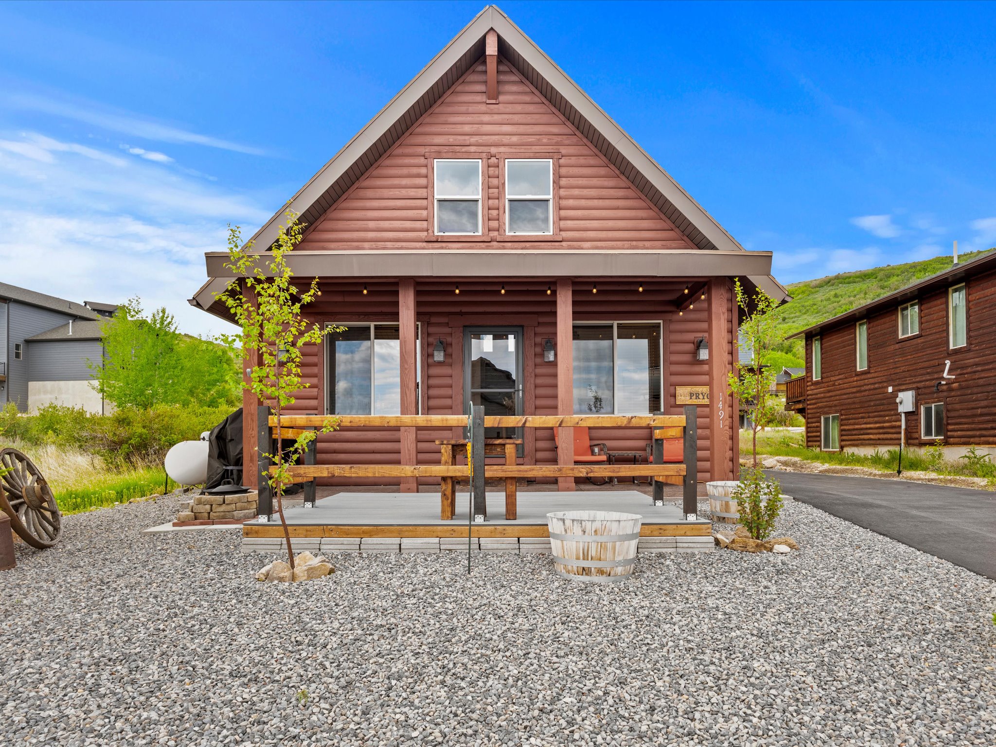 Redwood-tone log siding exterior featuring a gable roofline and prominent front porch